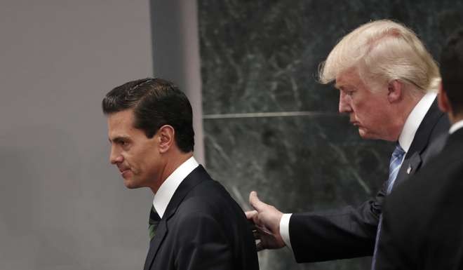 Donald Trump walks with Mexico President Enrique Pena Nieto at the end of their joint press conference at Los Pinos, the presidential residence, in Mexico City on August 31. Photo: AP