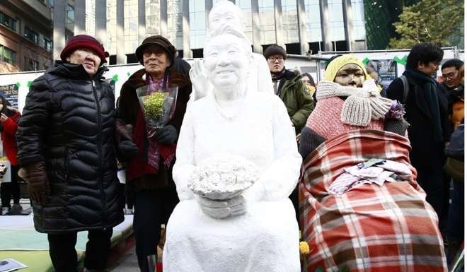 Gil Won-ok (left) and Kim Bok-dong (second from left), who were forced to serve as sex slaves for the Japanese Imperial Army during the second world war, join a rally in Seoul this week. Only 39 women are still alive out of the 238 who have been acknowledged as “comfort women” survivors by the government. Photo: EPA