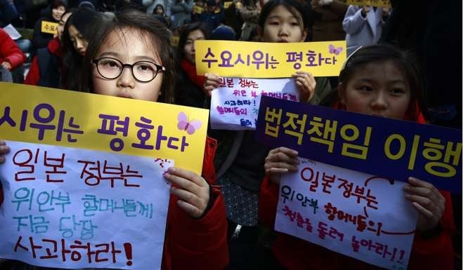 South Korean schoolchildren hold placards calling for an apology from the Japanese government, during a rally this week to mark the 25th anniversary of weekly demonstrations in front of the Japanese embassy in Seoul to demand a resolution of the issue. Photo: EPA