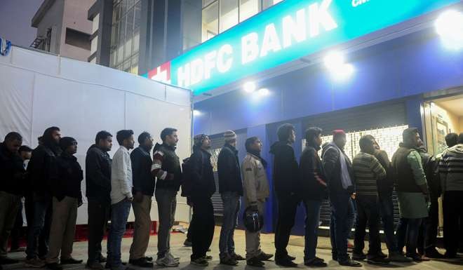 Indians queue at an ATM in Allahabad. Modi’s move to withdraw 1,000 and 500 rupee notes has made long queues commonplace. Photo: AFP