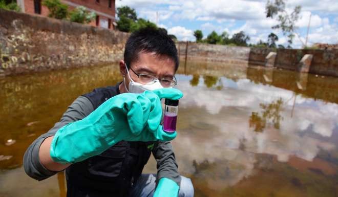 Ma Tianjie pictured collecting a sample of polluted water at a chemical plant in Yunnan province in 2011. Photo: Greenpeace