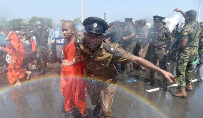 Sri Lankan police use a water canon to disperse activists and monks during a protest in the southern port city of Hambantota. Photo: AFP
