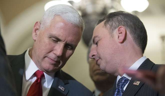 US Vice President-elect Mike Pence (left) listens to incoming White House Chief of Staff Reince Priebus during a news conference on Capitol Hill in Washington last week. Photo: EPA