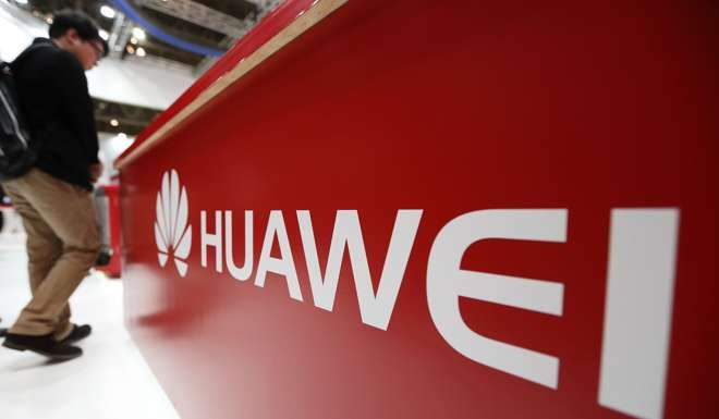 An attendee walks past a Huawei sign displayed at a trade show in Chiba, Japan, in 2015. The firm has long faced unsubstantiated allegations of spying. Photo: Bloomberg