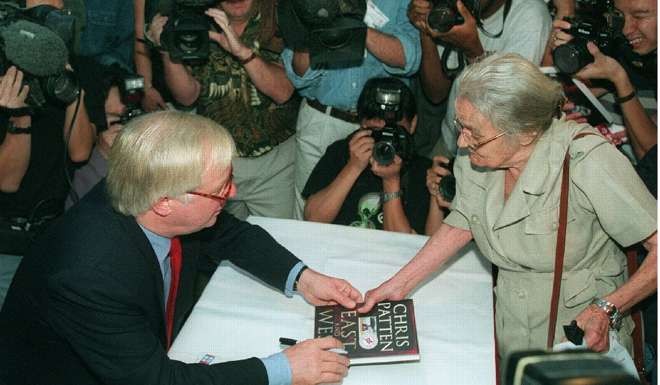 Former Hong Kong governor Chris Patten signs his book for 87-year -old Hollingworth. Photo: Handout