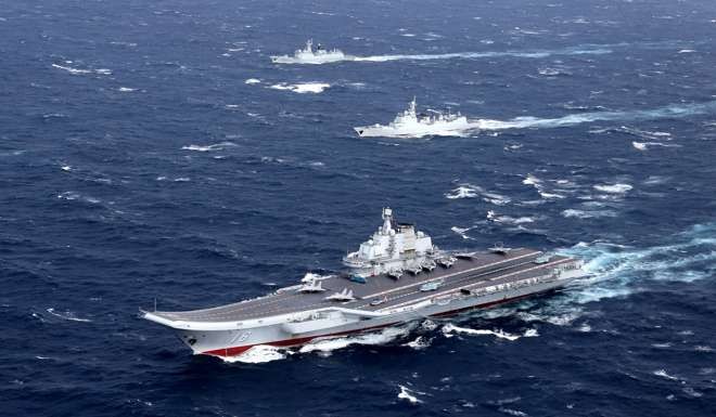 China's Liaoning aircraft carrier with accompanying fleet conducts a drill in an area of South China Sea in December: Photo: Reuters