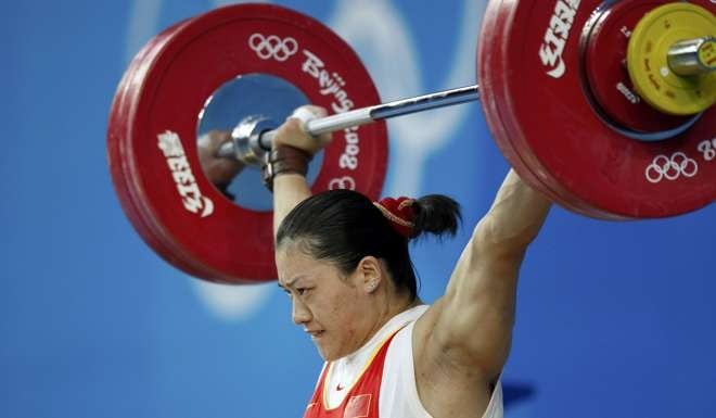 Cao Lei sets an Olympic record of 128kg in the 75kg Group A snatch competition at the Beijing Games. Photo: Reuters