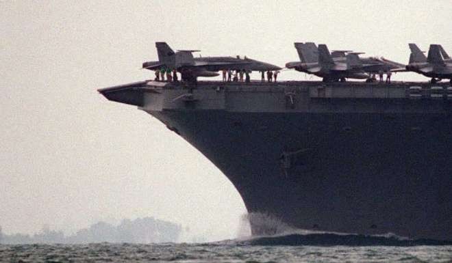 The US aircraft carrier Nimitz enters the South China Sea near Singapore with its deck loaded with planes. Photo: AFP