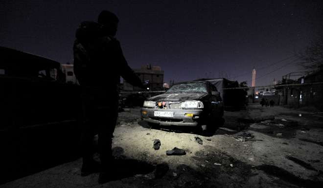 A man inspects damage after an explosion in Kafr Sousa neighbourhood of Damascus on Thursday. Photo: Reuters