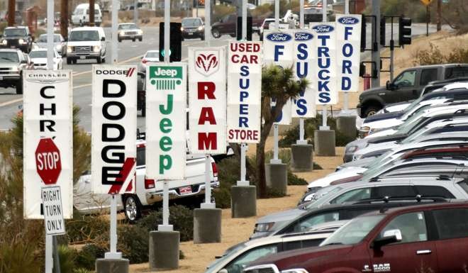 Banners for automobile brands adorn a dealership in Yucca Valley, California. Photo: EPA