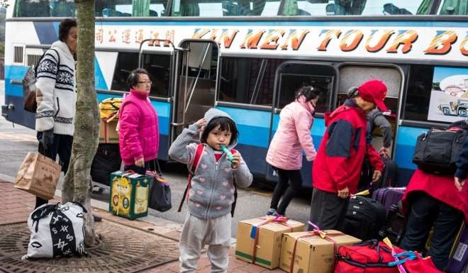 A tour group from the Chinese mainland unpacks its luggage at a ferry terminal in Kinmen. Photo: Sim Chi Yin / VII