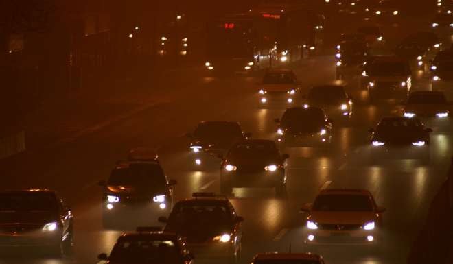 Cars drive in heavy smog in Beijing File photo: Reuters