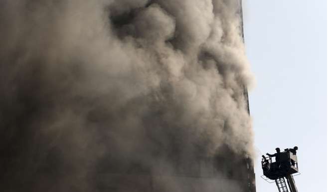 Iranian firefighters work to extinguish fire of the Plasco building. Photo: AP
