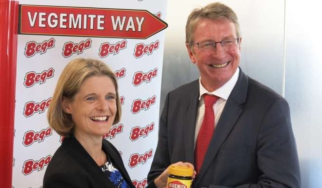Mandelez managing director for Australia and New Zealand Amanda Banfield hands over Vegemite (literally, in this case) to Bega Cheese executive chairman Barry Irvin. Photo: EPA