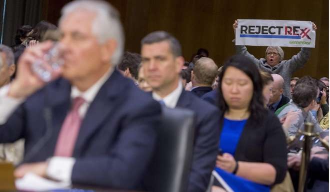 A protester stands up as former ExxonMobil executive Rex Tillerson testifies earlier this month during his confirmation hearing for secretary of state before the Senate Foreign Relations Committee on Capitol Hill. The Trump-Tillerson foreign affairs team is the least prepared in modern American history. Photo: AFP