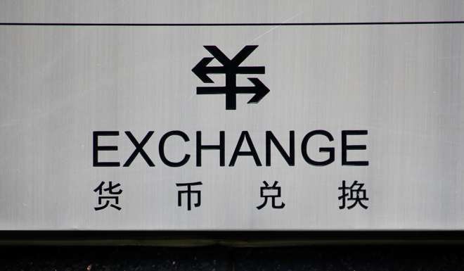 A sign for foreign currency exchange is seen at a branch of the ICBC bank in Beijing. Photo: Reuters