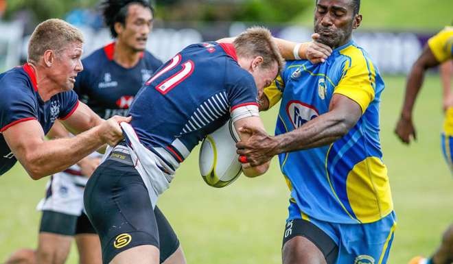Alex McQueen takes on the tackler at the Coral Coast Sevens.