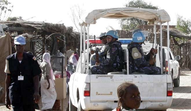 UN peacekeepers drive through Kalma refugee camp in Darfur, Sudan. Photo: AP