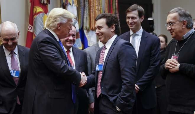 US President Donald Trump, second left, shakes hands with Mark Fields, president and chief executive officer of Ford Motor. Photo: Bloomberg