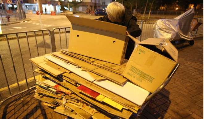An elderly woman makes a meagre living by collecting cardboard boxes. Ever-rising living expenses, especially sky-high rents, have left nearly one million people in Hong Kong, or one in every seven, in poverty. Photo: Edward Wong