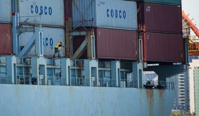 Unloading containers from a COSCO cargo ship at the Port of Vancouver terminal in Vancouver. Photo: Bloomberg