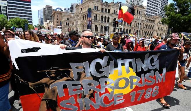 Demonstrators - many wearing the black, yellow and red colours of the aboriginal flag - gathered Brisbane. Photo: Reuters