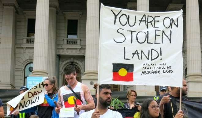 Protesters demonstrate outside the Victorian State Parliament on Australia Day in Melbourne. Photo: Reuters