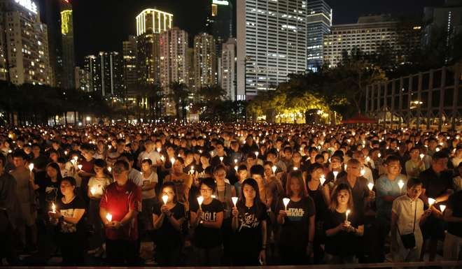 Tens of thousands attend a candlelight vigil at Victoria Park on June 4 last year. The annual vigil commemorates victims of the 1989 military crackdown on young protesters at Beijing’s Tiananmen Square, an episode largely missing from history textbooks in mainland China. Photo: AP