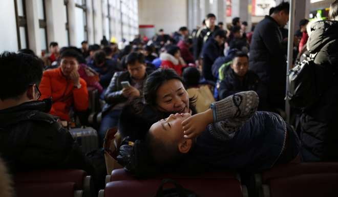 People waiting for trains at Beijing Railway Station. Photo: EPA