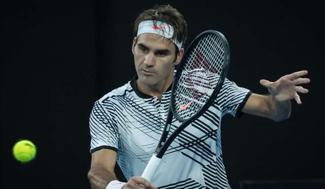 Roger Federer of Switzerland returns the ball against compatriot Stan Wawrinka. Photo: Xinhua