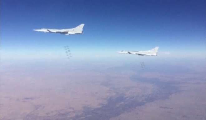 Russian Tupolev Tu-22M3 long-range bombers dropping bombs on Islamic State targets in Deir al-Zor province, Syria. Photo: Reuters