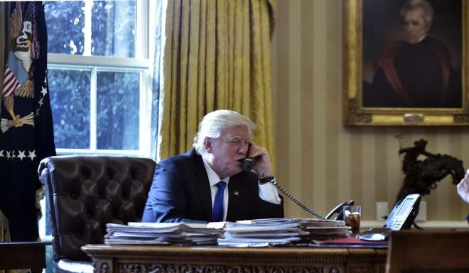 US President Donald Trump speaks on the phone with Russia's President Vladimir Putin. Photo: AFP