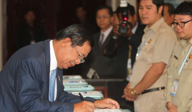 Cambodia's Prime Minister Hun Sen signs a register as he arrives before a plenary session at the National Assembly of Cambodia, in central Phnom Penh. Photo: Reuters