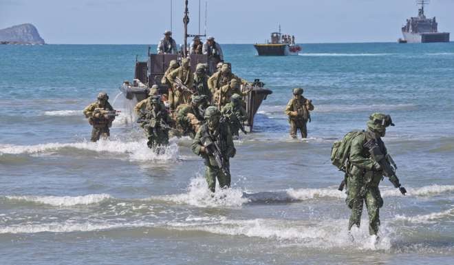 Australian and Singapore soldiers disembark a Fast Craft Utility landing vessel at Shoalwater Bay training area, Queensland. Photo: DOD