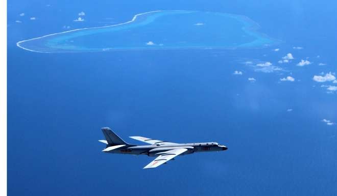 A Chinese bomber patrols islands and reefs in the South China Sea, where China is reported to have installed anti-aircraft and anti-missile weapons on its man-made islands, created by piling sand on top of coral reefs. Photo: Xinhua via AP