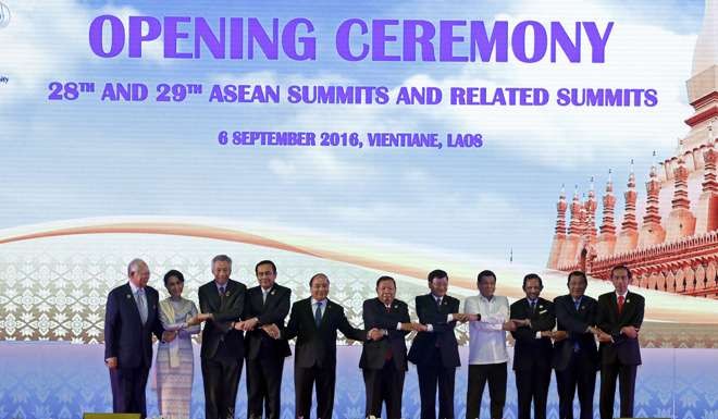 Indonesia’s President Joko Widodo (far right) and other Asean leaders link hands for the customary group photo during the opening ceremony of the 28th and 29th Asean Summits and Related Summits in Vientiane, Laos, last September. All 10 Asean member states are signatories to the Beijing-led Regional Comprehensive Economic Partnership. Photo: EPA