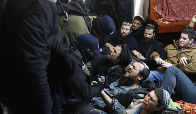 Israeli settlers scuffle with security forces at the Amona outpost. Photo: AFP