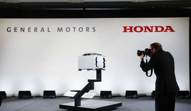 A photographer captures images of the General Motors-Honda Next Generation Fuel Cell after a news conference in Detroit. Photo: AP