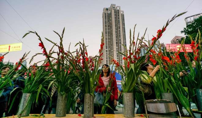 Customers browse at the Victoria Park New Year flower market late last month. Photo: AFP
