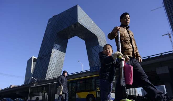 The CCTV Tower looms in the background in the Beijing’s central business district. Photo: AFP