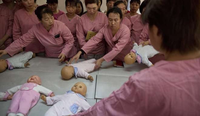 Maternity matrons learn to take care of babies during training classes in Beijing in 2015, with demand for their services expected to increase after China had abandoned its decades-old one-child policy. Photo: AP