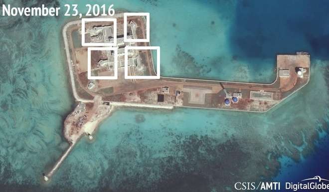 A satellite image shows what CSIS Asia Maritime Transparency Initiative saysappears to be anti-aircraft guns and other weapons believed to have been built by China on the artificial island Hughes Reef in the South China Sea. Photo: Reuters