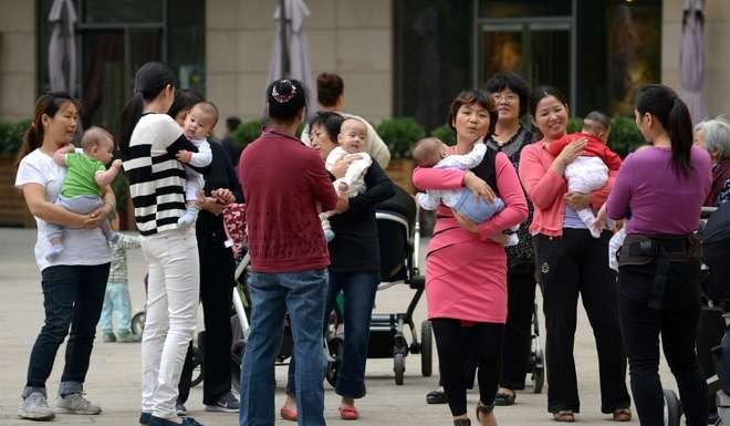 Women gather with their babies at a residential area in Beijing in September 2014. China began to loosen its one-child policy on January 17 that year, when Zhejiang province made it legal for couples to have two children if one parent was an only child. Photo: AFP