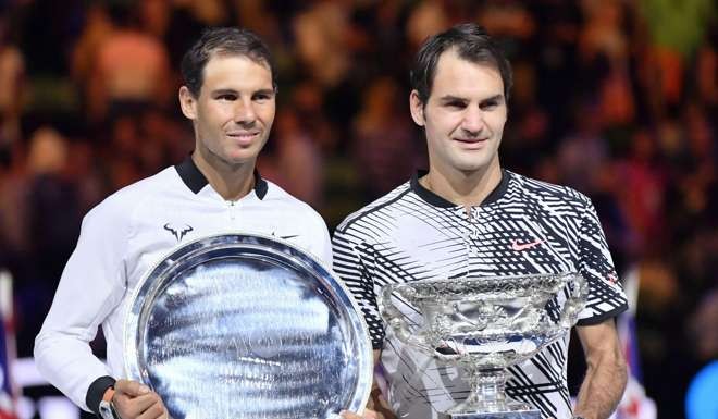 Rafael Nadal and Roger Federer with their trophies after the epic encounter. Photo: Kyodo