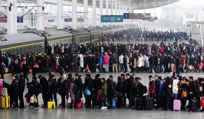 People wait to board a train on the last day of Chinese Lunar New Year holidays at a railway station in Jiujiang, Jiangxi province. Photo: Reuters
