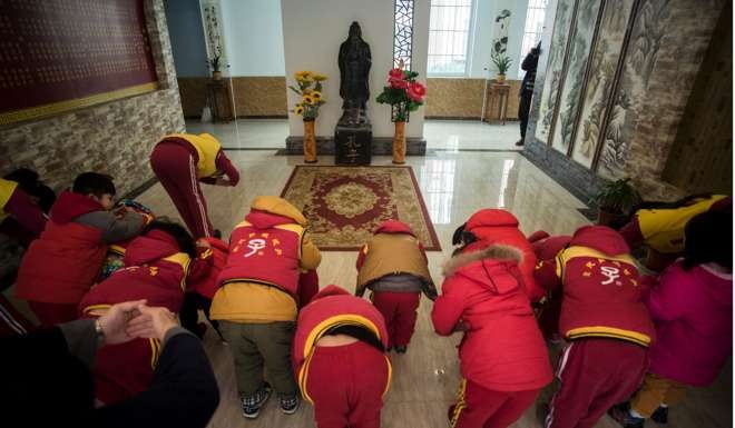Children bow before a statue of Confucius after a class at a Confucius kindergarten in Wuhan, Hubei province, last year. Distinct ethnic-cultural underpinnings of the Chinese world order are drawn largely from Han Confucianism. Photo: AFP