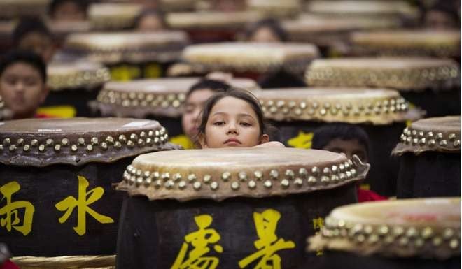 Young drummers get ready for a performance in Kuala Lumpur, Malaysia. The drumming, part of the Malaysian Chinese culture, has its origins in harvest festivals in China. How China chooses to respond to overseas Chinese affairs in general, and those in Malaysia in particular, remains a delicate matter of international diplomacy and politics. Photo: AP